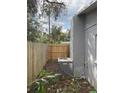 View of the side yard showing a new wooden fence and the home's AC unit at 14002 Morgan St, Dade City, FL 33525
