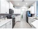 Well-lit kitchen features stainless steel appliances, modern cabinets, and tile backsplash at 2626 Scenic Park Loop, Wimauma, FL 33598