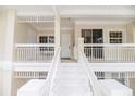 Condo porch with white railing, stairs, and lovely outdoor space at 3608 54Th W Dr # 202, Bradenton, FL 34210