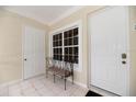 Inviting entryway featuring a window, tiled floor, and convenient bench seating at 3608 54Th W Dr # 202, Bradenton, FL 34210