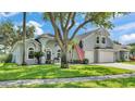 Charming home with a three-car garage, manicured lawn, and beautiful landscaping at 3911 Smoke Rise Ct, Valrico, FL 33594