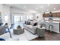 Bright, open living space with modern furniture, dining area, and kitchen with breakfast bar at 6930 161St E Ter, Parrish, FL 34219