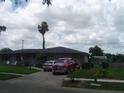 Charming single-story home with a well-maintained lawn and tidy landscaping features at 704 Queens Ct, Seffner, FL 33584