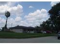 Charming single-story home with a well-maintained lawn and tidy landscaping features at 704 Queens Ct, Seffner, FL 33584