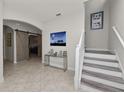 Bright foyer with an accent table and staircase leading to the upper level at 1044 Oliveto Verdi Ct, Brandon, FL 33511