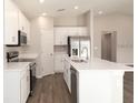 Bright kitchen with white cabinets, stainless steel appliances, and a large kitchen island at 2572 58Th E Cir, Palmetto, FL 34221