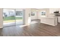 Open concept living area with sliding glass doors to backyard and adjacent kitchen at 2572 58Th E Cir, Palmetto, FL 34221