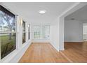 Bright and airy sun room featuring many windows and wood flooring at 275 Garden Rd, Venice, FL 34293
