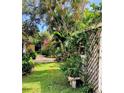 Private backyard featuring lush greenery, colorful flowers, and a charming fence, for serene outdoor living at 4718 Crystal Ave, Sarasota, FL 34231