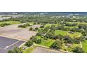Overhead shot of a sprawling property with fields, greenery, and some residential dwellings at 1309 Joe Mcintosh Rd, Plant City, FL 33565