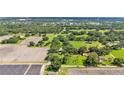 Scenic aerial view of a countryside property surrounded by green fields and tree lines at 1309 Joe Mcintosh Rd, Plant City, FL 33565