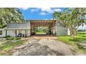 Exterior shot of a barn or garage-type building adjacent to a home at 1309 Joe Mcintosh Rd, Plant City, FL 33565