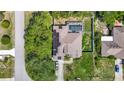 Aerial view of the property featuring a screened pool, solar panels, and a spacious yard at 173 Portland Ave, Spring Hill, FL 34606