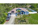 Inviting blue single-Gathering home with mature landscaping, solar panels, and a two-car garage at 173 Portland Ave, Spring Hill, FL 34606