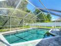 Relaxing screened pool with a brick deck, perfect for enjoying the outdoors in privacy at 173 Portland Ave, Spring Hill, FL 34606