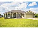 Lovely single-story home with a well-manicured lawn, arched windows, and a two-car garage at 3730 Ralston Rd, Plant City, FL 33566