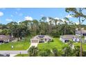 Well-maintained home featuring lush landscaping, solar panels, and a welcoming front entrance at 4592 Crabapple Ave, North Port, FL 34287