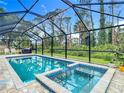 Inviting screened pool and spa with beautiful blue tile, perfect for relaxation and outdoor entertainment at 4592 Crabapple Ave, North Port, FL 34287