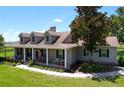 Charming home with a covered porch, perfect for relaxing and enjoying the view, surrounded by greenery at 4611 Executive Meadows Dr, Plant City, FL 33567