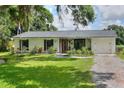 Beautiful single-story home with a lush green lawn, brick exterior, and welcoming entrance at 4616 Edwards Rd, Plant City, FL 33567