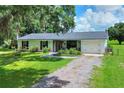 Quaint single-story house with a well-kept lawn, brick facade, and a cozy, inviting appearance at 4616 Edwards Rd, Plant City, FL 33567