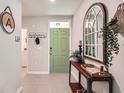 Bright entryway with stylish console table and decorative mirror at 32668 Abby Lax Ln, Wesley Chapel, FL 33543