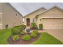 Well maintained home with a front lawn and garden at 32668 Abby Lax Ln, Wesley Chapel, FL 33543
