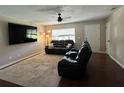Inviting living room with neutral paint, a ceiling fan, and ample natural light at 37341 Rutledge Dr, Zephyrhills, FL 33541