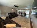 Inviting living room area that blends seamlessly with a modern kitchen at 37341 Rutledge Dr, Zephyrhills, FL 33541