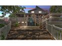 A cozy backyard featuring a stone paver patio, mature trees, stairs and two-story home at 9934 Peninsular Dr, Gibsonton, FL 33534