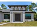 Close up of the elegant front entrance with double doors, modern design elements, and well-maintained landscaping at 3157 Bay City Ter, North Port, FL 34286