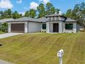 Charming one-story home with a two-car garage, stylish front entrance, and well-kept lawn for a welcoming curb appeal at 3157 Bay City Ter, North Port, FL 34286