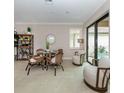 Casual dining area with wicker chairs and access to pool at 930 E Venice Ave, Venice, FL 34285
