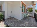 Front entry of villa with seating area and landscaping at 117 Clifton Way, Venice, FL 34292