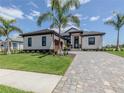 Luxury home with tile roof and paver driveway at 1729 Lugano Cir, Nokomis, FL 34275
