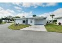 Single-story home with carport, landscaping and paved driveway at 383 Circlewood Dr # Z-8, Venice, FL 34293