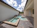 Private pool and spa with stone patio and covered lanai at 922 E Venice Ave, Venice, FL 34285