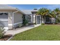 Front entrance of a single story home with lush landscaping at 3819 Ragen St, North Port, FL 34287