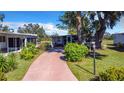 Mobile home exterior with paved driveway and landscaping at 5216 Palena Blvd, North Port, FL 34287