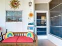 Enclosed porch with bench and beach-themed decor at 5216 Palena Blvd, North Port, FL 34287
