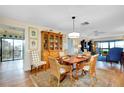 Bright dining room with wood table and wicker chairs at 1068 Bird Bay Way # 297, Venice, FL 34285