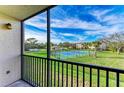 Relaxing screened balcony overlooking the tennis court and lake at 1999 Kings Hwy # 134B, Port Charlotte, FL 33980