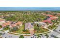 Aerial view showcasing a single-Gathering house with a circular driveway at 5674 Blue Heron Cir, North Port, FL 34287