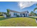 Newly renovated home with a large green lawn at 18091 Eau Gallie Cir, Port Charlotte, FL 33948