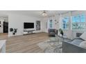 Modern living room with gray sofas and a large TV at 18091 Eau Gallie Cir, Port Charlotte, FL 33948