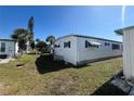View of the side of a white single-wide mobile home at 213 Como Dr, Venice, FL 34285