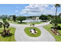 Aerial view of community featuring a pond, lush landscaping, and ample parking at 1900 59Th N Ave # 308, St Petersburg, FL 33714