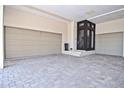 Spacious three-car garage featuring a tiled floor and convenient access to the residence at 361 Benjamin Franklin Dr # A, Sarasota, FL 34236