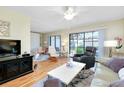 Living area with hardwood floors, comfortable furniture, and access to patio at 744 White Pine Tree Rd # 103, Venice, FL 34285