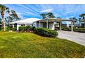 Charming single-story home with well-manicured lawn and a covered carport at 266 Cerromar S Way # 55, Venice, FL 34293